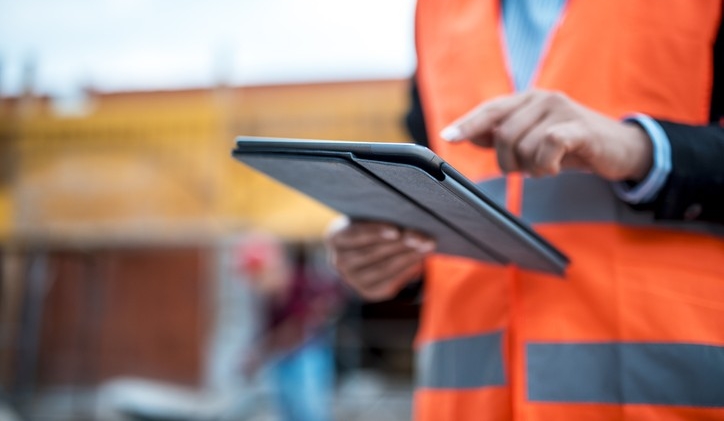 Technology is also part of construction industry Two architects are using digital tablet on construction site.